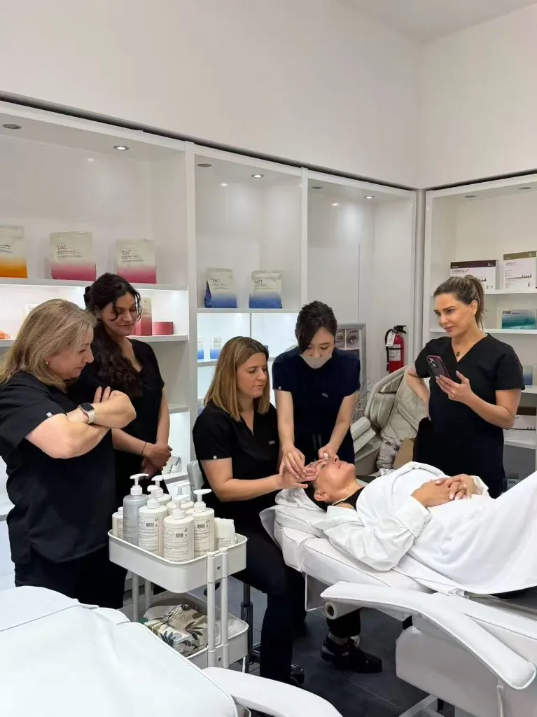 On-site team observing a live Express Facial demonstration